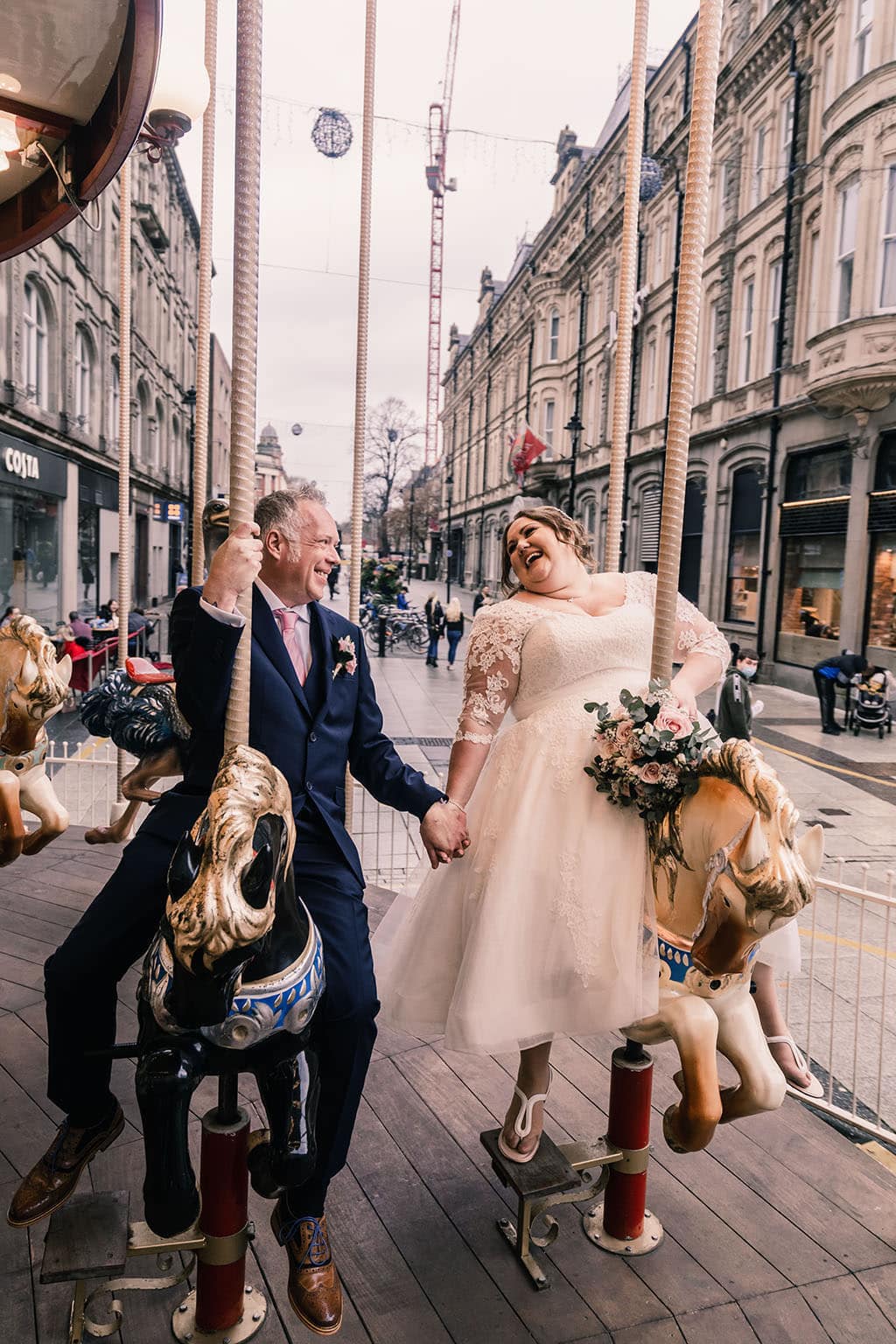 Bride and Groom on carousel in Cardiff City Center